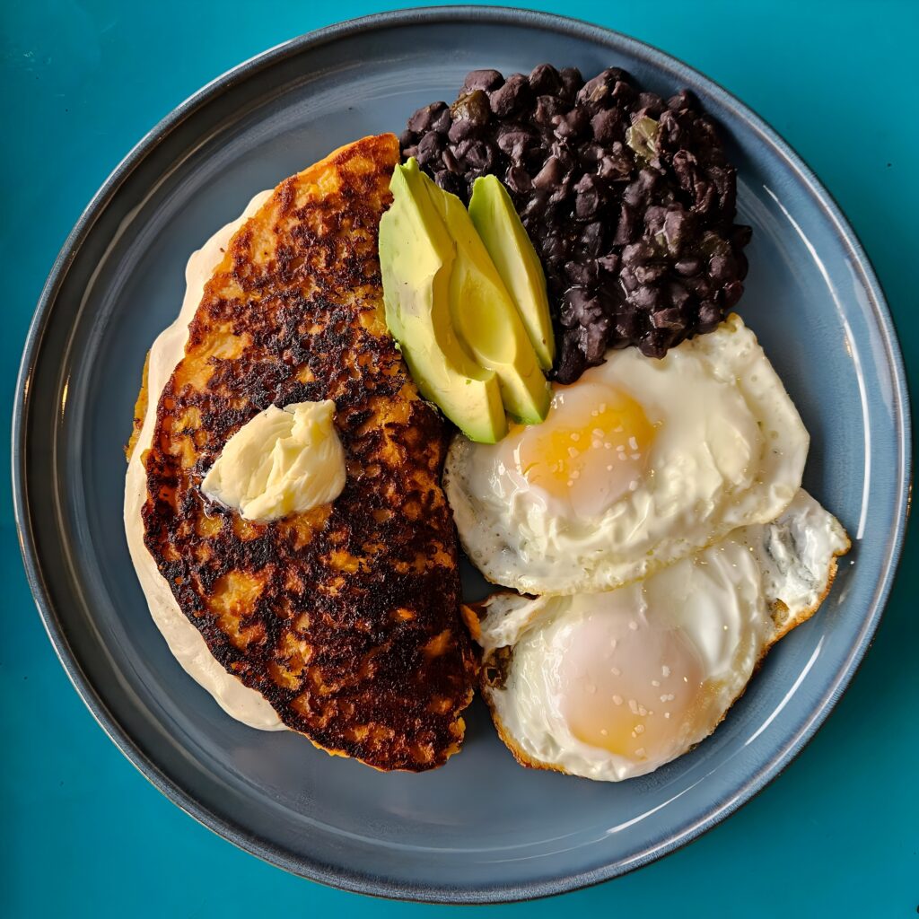 Sweet corn cachapa with eggs, cheese, black beans, and avocado from Coma Arepas in Kenner